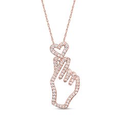 Display your love with this shimmering diamond heart and hand outline pendant in rose gold-plated silver. Fashioned in sterling silver with 14K rose gold plate A hand-shaped outline holds a dainty open heart. 1/5 ct. t.w. of diamonds lines the design in sparkle. This pendant suspends along an 18.0-inch rope chain that secures with a spring-ring clasp. Heart And Hand, Hand Outline, Minimal Pendant, Rings Opal, Rose Gold Plate, Luxury Jewellery, Engagement Rings Opal, Heart Pendant Diamond, Jewelry Design Necklace