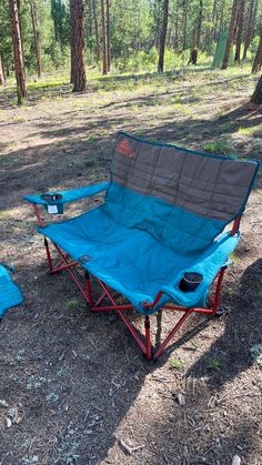 a camping chair and table set up in the woods