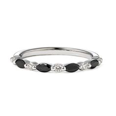 a white gold ring with black and clear stones