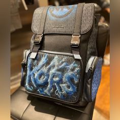 Certainly! Your Customized Men's Michael Kors Cooper Utility Signature Rucksack Backpack Is A True Work Of Art. Imagine A Frozen World Where Style Meets Functionality. This Backpack Boasts A Bold Kors Graphic, Creatively Designed In A Graffiti Frozen Letter Style, Giving The Impression That The Letters Are Sculpted From Shimmering Blue Ice. It's Not Just A Backpack; It's A Statement Piece That Combines Urban Edge With A Touch Of Frosty Elegance. Perfect For Those Who Appreciate The Fusion Of Fas Designer Backpack With Dust Bag, Designer Leather Backpack With Logo, Luxury Blue Backpack Bag, Blue Bag With Adjustable Strap, Luxury Blue Standard Backpack, Luxury Blue Backpack, Blue Leather Bag For Outdoor Use, Blue Leather Bag For Outdoor, Designer Standard Travel Backpack