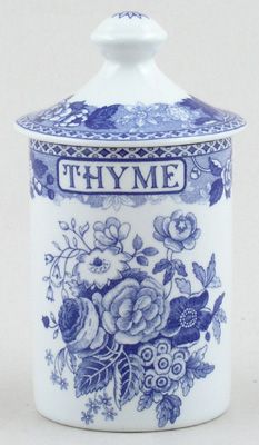 a blue and white vase with flowers on it's lid that says thye