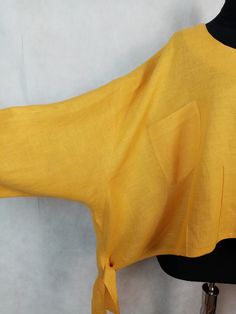 Yellow summer blouse by Te Hamburg, crew neck line, long sleeve, asymmetrical hem with ties and loose waist fit. 100% linen, plus size, in very good, clean condition. His blouse is a loose-fitting cut and flat measures approx - length/measured from the top of the shoulder to the bottom of the hem/ - 50 cm/ 19.8'' chest - 78 cm/ 30'' Casual Linen Tops With Asymmetrical Hem, Casual Linen Top With Asymmetrical Hem, Lagenlook Linen Tops With Asymmetrical Hem, Yellow Relaxed Fit Linen Blouse, Linen Lagenlook Top With Asymmetrical Hem, Yellow Long Sleeve Linen Top, Yellow Asymmetrical Summer Tops, Oversized Yellow Top With Pockets, Chic Yellow Asymmetrical Top