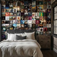 a bed sitting in a bedroom next to a wall full of pictures on the wall