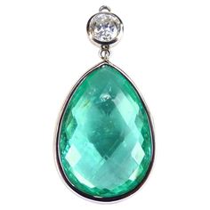 This 950/ Platinum (9.90g) Pendant is set with 1x fine Paraiba Tourmaline (Briolette-cut, 28x20x10mm, 38.79ct) + 1x Diamond (Brilliant-cut, 1.65ct, round 6.8mm, G/P2). Paraiba Tourmalines are very popular and rare gemstones. The color is electric neon blue/greenish and has a kind of fluoreszens caused by copper inside. This effect gives those stones a magical glow and "lightning in the dusk", inside & outside. The gem is renowned for its light reflecting properties that create a mesmerising effe White Gold Pendant Necklace, Contemporary Jewelry Design, Paraiba Tourmaline, Tourmaline Necklace, Rare Gemstones, Modern Necklaces, Inside Outside, Antique Diamond, Neon Blue