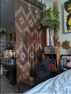 a bed room with a fan and pictures on the wall