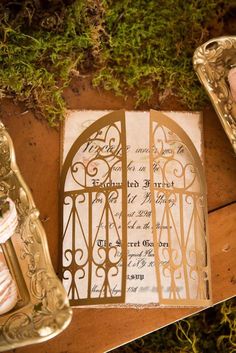 the wedding stationery is decorated with gold and white paper