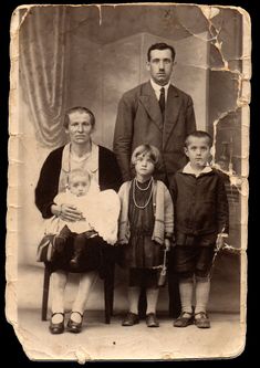 an old black and white photo of a family posing for a photograph with their children