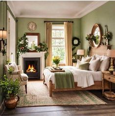 a bedroom with green walls, white bedding and a fireplace in the corner between two windows