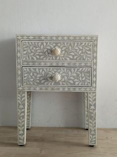 a white and grey table with two drawers on one side and an open drawer on the other