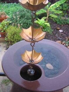 a water fountain with three leaves on it