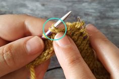 someone is crocheting the end of a small piece of yarn with a needle