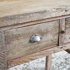 an old wooden table with some metal knobs on it's drawer and handles