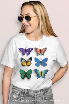 This butterfly shirt has a colorful retro and vintage inspired graphic of butterflies, giving the tshirt a cool aesthetic. This graphic tee is made of exceptionally soft, lightweight fabric and has a modern UNISEX fit. Makes a great gift for her! Summer Graphic Tee With Butterfly Print, Trendy Short Sleeve T-shirt With Butterfly Print, Trendy Cotton T-shirt With Butterfly Print, Trendy White T-shirt With Butterfly Print, Vintage Butterfly Print T-shirt For Summer, White Butterfly T-shirt For Summer, Short Sleeve Graphic Tee With Butterfly Print, Short Sleeve Butterfly Print Graphic Tee, Summer Cotton T-shirt With Butterfly Sleeves