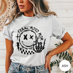 Motocross Shirt, Motocross Mama Race T-Shirt, Race Day Tee, Race Day Vibes, Race Season, Gifts for Racing, Motocross Shirt, Sports Mom 🖤 Processing time 3-10 business days (excludes the weekend) 🖤 SHIPPING INFO 3-5 business days (excludes the weekend)  It is that time of year where shipping delays across all carriers are at an all time high. We urge customers to please plan for the full production time frame and plan for shipping to take long then usual. First Class shipping DOES NOT include i White Biker Top With Letter Print, Casual Crew Neck Tops For Motorcycling, Moto Style Graphic Print Crew Neck T-shirt, Letter Print Crew Neck Tops For Biker Events, Moto Style Cotton Top With Graphic Print, Casual Motorcycling T-shirt With Screen Print, Casual Motorcycle T-shirt With Custom Print, Casual T-shirt With Custom Print For Biker Events, White Moto Crew Neck T-shirt