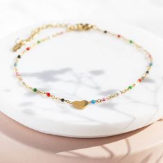 A beautiful muti coloured enamel bead anklet with heart detail. This bright and playful heart anklet is a must have accessory for Spring/Summer. Its beaded chain will add a pop of colour to any outfit and is sure to bring JOY on the ankle of the wearer. A lovely personalised gift or self indulgent treat. The item is presented on the sentiment card of your choice in a lovely organza gift bag, ready to give or keep. If you would like to upgrade your purchase to include a gift box please order here Trendy Multicolor Heart Bracelet With Colorful Beads, Trendy Multicolor Beaded Heart Bracelet, Multicolor Beaded Chain Anklets As Gift, Trendy Multicolor Anklets As A Gift, Trendy Multicolor Anklets For Gift, Trendy Multicolor Anklets As Gift, Trendy Colorful Beaded Anklets As Gift, Trendy Multicolor Heart Charm Bracelet, Trendy Heart Shaped Anklets For Gift