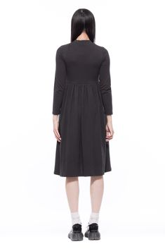 Think Audrey Hepburn classic cool chic dress. An easy pieces for a colder weather with long sleeves and mock neck.