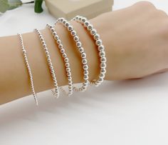 Sterling silver stretch bracelet beaded with Sterling silver 2mm,3mm,4mm, 5mm and 6mm beads. Great to wear alone or layered with other beaded bracelets. Bracelet measuring about 7inches with stretch. *Price is for one Bracelet. Add initials below  https://etsy.me/3IWjMIp All Jewelry is personalized and packaged in our small studio 🤍 * Order are shipped out 1-3 business days after the order as been received. If you need your order faster please upgrade at checkout * ** shipping ** All jewelry is packaged in anti tarnish plastic bags and neatly packed in a box or a gift bag and ready to gift. If you need extra gift boxes leave us a message at checkout ** Returns ** Returns can be made within 14 days of receiving your order. We will provide you with instructions on mailing your package back. Personalized Silver Bracelets, Goddaughter Gifts, Monogram Bracelet, Bracelet Initial, Minimalist Women, Custom Bracelet, Jewelry Personalized, Initial Bracelet, Bracelet Argent