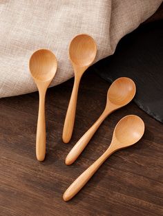 three wooden spoons sitting on top of a table