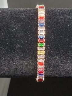 Stunning rose gold bracelet with multicolor glass gems. Elegant Rainbow Bracelets For Parties, Elegant Rainbow Colored Bangle Jewelry, Elegant Multicolor Crystal Bracelet, Elegant Multicolor Metal Bracelet, Elegant Multicolor Metal Bracelets, Multicolor Bracelet Jewelry For Party, Multicolor Bracelet For Party, Multicolor Cubic Zirconia Rhinestone Jewelry, Multicolor Rhinestone Cubic Zirconia Jewelry