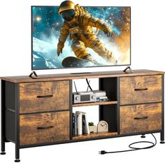 an entertainment center with a large television on top of it