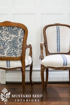 two chairs sitting next to each other on top of a hard wood floor