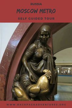 a bronze statue sitting on top of a wooden floor next to a red and white sign