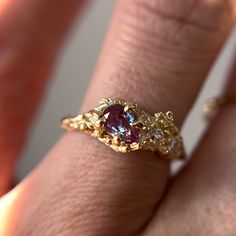 "This Juniper Cluster Ring features a shimmering purple, pear cut alexandrite set asymmetrically amongst a cluster of diamonds. The rustic and textured band is molded from an Ashe Juniper tree. 100% recycled gold  100% lab grown diamond & alexandrite Every single ring in my collection is designed, sculpted and produced entirely by hand. I never use computers and I never use \"off-the-shelf\" designs that you see in so many jewelry stores. Each ring begins by casting an actual twig or piece of ba Asymmetrical Gold Ring, Artsy Engagement Rings Unique, Unique Engagement Rings Art Deco, Bee Engagement Ring, Freeform Engagement Rings, Fairy Style Engagement Ring, Eclectic Rings Engagement, Eclectic Engagement Ring, Engagement Rings Organic