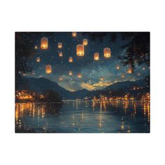 lanterns floating in the air over water at night with mountains and sky reflected in the water