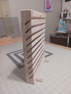 a large wooden object sitting on top of a white tile floor