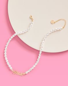 "✨Classic Bride: keep it classy in our gold nameplate necklace featuring BRIDE letters on a faux pearl string necklace. ✨Perfect Length: our delicate necklace hits at 16\" long + comes with a 2\" extender. It can be styled as a loose choker or necklace. ✨Bride Nameplate: the bride charm measures 1 \" long and .4\" tall; necklace features a lobster claw closure, easy to open and close! ✨Versatile Queen: this pearl + gold necklace is the perfect bachelorette party jewelry, bridal shower accessory Gold Nameplate Necklace, Wedding Necessities, Nameplate Necklace Gold, String Necklace, Classic Bride, Bride To Be Sash, Bride Necklace, Pearl Beaded Necklace, Classic Brides