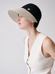 a woman wearing a black and white hat