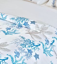 a bed with blue and white sea life on it