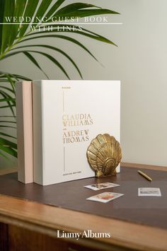 a book sitting on top of a table next to a plant