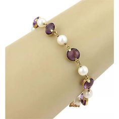 This elegant vintage bracelet is crafted from 18k yellow gold with a polished finish. It has alternating amethyst gemstones beads with pearls, all attached and joined together between small chain links. It secures with a push in clasp and chain attached and it is signed 18k.  Material: 18k yellow gold Measurement: 7" long x 9.1mm wide x 6.8mm wide Gemstone: Amethyst: 8.3mm each Pearls: 6.8mm each Weight: 13 grams Gold Bead Bracelet, Gold Bead Bracelets, Chain Links, Vintage Bracelet, Vintage Bracelets, Amethyst Gemstone, Bead Bracelet, Gold Beads, Chain Link