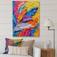 a living room with a white couch and colorful painting on the wall