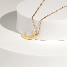 This stunning necklace features a beautifully crafted pendant with a personalized Arabic letter. The elegant design of the letter captures its unique and intricate beauty, making it a focal point of sophistication and charm. The pendant hangs from a delicate chain, perfect for adding a touch of elegance to any outfit. Ideal for everyday wear or special occasions, this necklace makes a meaningful and stylish statement. It also serves as a thoughtful and personalized gift for loved ones, celebrati Initial Pendant Name Necklace With Adjustable Chain, Formal Initial Pendant Necklace, Personalized Initial Pendant Name Necklace With Adjustable Chain, Elegant Initials Charm Necklace, Formal Initial Pendant Necklace With Clavicle Chain, Initial Pendant Name Necklace With Adjustable Chain As Gift, Formal Initials Necklace With Round Pendant, Elegant Initials Pendant Jewelry, Elegant Initial Necklace With Adjustable Chain And Round Pendant