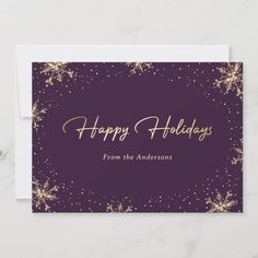 a purple and gold holiday card with snowflakes on the front, says happy holidays from the andersons