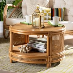 a wicker coffee table with books and cups on it