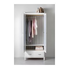 a white cabinet with clothes hanging on it