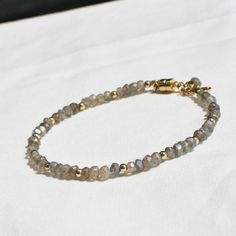 Gorgeous labradorite is hand strung to create this beaded bracelet. Accented with 14kt gold filled touches. D E T A I L S *Hand strung *natural labradorite *14kt gold filled accent beads *Fits up to a 7 inch wrist If you would like a longer length we can use a lobster clasp and add an extender, just leave us a note! ∙ EXTRA LOVE ∙ Handcrafted just for you in sunny Arizona by a team of talented women. All of our jewelry comes gift packaged! We are happy to leave a note if this is a special gift, Gold Labradorite Bracelet As Gift, Elegant Adjustable Labradorite Beaded Bracelets, Gold Labradorite Bracelets With Natural Stones, Elegant Labradorite Beaded Bracelets, Hand-strung Labradorite Gold Jewelry, Gold Labradorite Bracelet With Natural Stones, Adjustable Beaded Labradorite Bracelets, Handmade Adjustable Labradorite Beaded Bracelets, Adjustable Labradorite Beaded Bracelets