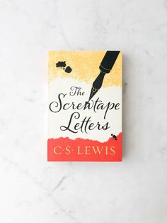 the screetape letters by c s lewis on a white marble table top