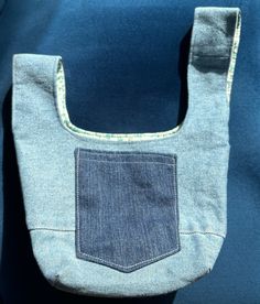 a denim bag with a pocket on it