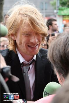 a man in a suit and tie talking to someone