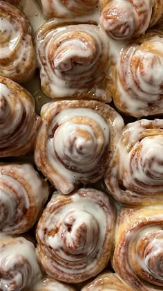 there are many cinnamon rolls with icing on them