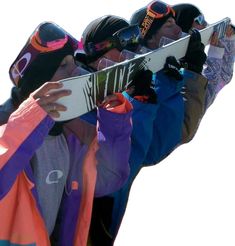 the snowboarders are holding their boards high in the air while wearing goggles