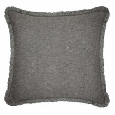 a gray pillow with fringe trim