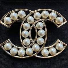 The Best Way To Glam Up Any Look, Without Going Over The Top, Is By Adding A Brooch To It. This Charming Piece From The House Of Chanel Features A Cc Interlocked Gold-Tone Body And Detailed With Faux Pearl On It. It Comes With A Pin Closure At The Rear. Cinch Your Scarf With It Or Simply Pin It To A Plain Blouse. Gold Tone Metal Faux Pearls 2017 Stamp Year Classic White Brooches For Evening, Classic White Evening Brooches, Designer Silver Brooches For Evening, Designer Silver Brooches For Wedding, Designer Silver Wedding Brooches, Designer Silver Brooch For Anniversary, Designer White Brooches For Wedding, Designer White Wedding Brooches, Classic White Brooch For Formal Occasions