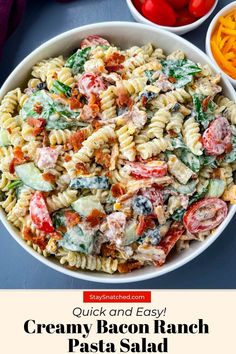 a bowl filled with pasta salad next to other ingredients