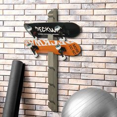 there is a skateboard on the wall next to a gym ball and exercise equipment