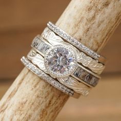 a close up of two rings on top of a tree branch with wood in the background